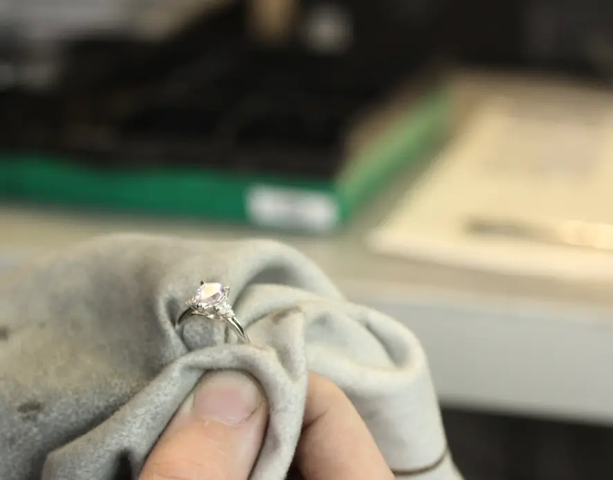 Close up of diamond ring being polished