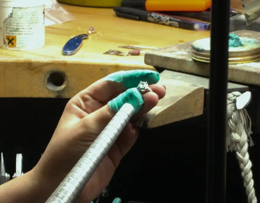 Close up of a diamond ring being measured for resizing